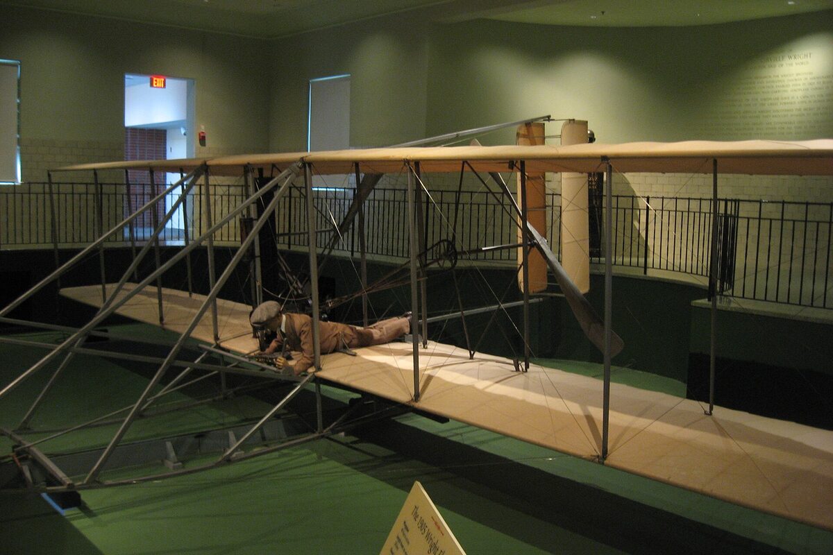 The 1905 Wright Flyer III biplane on display in a museum hall